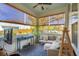 Inviting sunroom featuring a comfortable seating area, woven shades, and a tranquil view of the outdoors at 1810 Fleming Woods Rd, Charleston, SC 29412