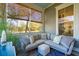Relaxing sunroom boasts a cozy sectional sofa and charming window views at 1810 Fleming Woods Rd, Charleston, SC 29412