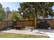 Private backyard with a wooden fence, a stone patio with outdoor furniture, and a grill covered for protection at 1826 Towne St, Johns Island, SC 29455