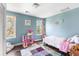 Bright bedroom featuring two windows, hardwood floors, and decorated with colorful furniture and decorations at 1826 Towne St, Johns Island, SC 29455