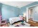 Cozy bedroom with a full-sized bed, hardwood floors, colorful rug, and view into a nearby bathroom at 1826 Towne St, Johns Island, SC 29455