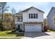Charming two-story home featuring a stone facade, a blue front door, and an attached two-car garage at 1826 Towne St, Johns Island, SC 29455