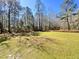Expansive backyard with lush green grass, mature trees, and ample space for outdoor activities at 1848 Merrick Dr, Round O, SC 29474