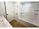 Bright bathroom boasts a white bathtub with shower, and a marble countertop on the vanity at 1848 Merrick Dr, Round O, SC 29474