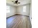Well-lit bedroom with two windows, neutral walls, and wood-look flooring at 1848 Merrick Dr, Round O, SC 29474
