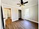 Spacious bedroom boasts neutral walls, wood-look flooring, and a view into an open closet at 1848 Merrick Dr, Round O, SC 29474