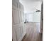 Open bedroom featuring light-blue walls, wood-look floors, and a ceiling fan at 1848 Merrick Dr, Round O, SC 29474