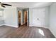 Spacious bedroom featuring light-blue walls, wood-look floors, closet, large windows, and ensuite bathroom at 1848 Merrick Dr, Round O, SC 29474