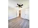 Bedroom with ceiling fan, wood-look flooring, and views of the bathroom at 1848 Merrick Dr, Round O, SC 29474