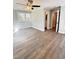 Spacious bedroom featuring light-blue walls, wood-look floors, large windows, and ensuite bathroom at 1848 Merrick Dr, Round O, SC 29474