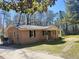 Charming single-story home with brick facade, covered porch, and mature trees in a large yard at 1848 Merrick Dr, Round O, SC 29474
