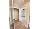 Hallway featuring modern wood-look floors, access to closet and bedrooms, blending convenience and style at 1848 Merrick Dr, Round O, SC 29474