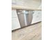 Stainless steel dishwasher nestled between white cabinets and warm countertops at 1848 Merrick Dr, Round O, SC 29474