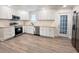Bright kitchen featuring white cabinets, stainless steel appliances, butcher block countertops, and wood-look flooring at 1848 Merrick Dr, Round O, SC 29474