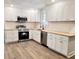 Updated kitchen with white cabinets, stainless steel appliances, and wood countertops at 1848 Merrick Dr, Round O, SC 29474
