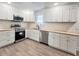 Bright kitchen featuring white cabinets, stainless steel appliances, butcher block countertops, and wood-look flooring at 1848 Merrick Dr, Round O, SC 29474