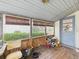 Enclosed back porch featuring wood flooring, a door to the exterior, and ample natural light at 1876 Chilhowee Dr, Johns Island, SC 29455