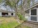 View of backyard with shed and screened porch surrounded by mature trees at 1876 Chilhowee Dr, Johns Island, SC 29455