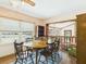 Bright dining room with a large window, wooden table, and view into the living room at 1876 Chilhowee Dr, Johns Island, SC 29455