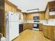 Traditional kitchen featuring wood cabinets, black appliances, and hardwood floors at 1876 Chilhowee Dr, Johns Island, SC 29455
