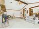 Cozy living room featuring exposed beams, brick fireplace, and staircase with railing detail at 1876 Chilhowee Dr, Johns Island, SC 29455
