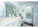 Bright bathroom with a large mirror, white cabinets, and modern fixtures at 1928 Chatelain Way, Mount Pleasant, SC 29464