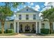 Beautiful two-story clubhouse with columns, white siding, and black windows creating an inviting community space at 1928 Chatelain Way, Mount Pleasant, SC 29464