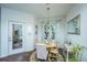 Bright dining room with a round wooden table, chandelier, and access to the outdoor patio at 1928 Chatelain Way, Mount Pleasant, SC 29464