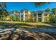 Brightly painted condo buildings with lush lawns and mature trees at 1928 Chatelain Way, Mount Pleasant, SC 29464