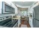 Bright kitchen with stainless steel appliances, granite counters, and a view into the dining area at 1928 Chatelain Way, Mount Pleasant, SC 29464