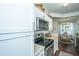 Stylish kitchen showcasing white cabinets, granite countertops, and stainless steel appliances at 1928 Chatelain Way, Mount Pleasant, SC 29464