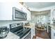 Modern kitchen features granite countertops, stainless steel appliances, and a view of the dining area at 1928 Chatelain Way, Mount Pleasant, SC 29464