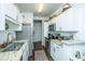 Well-lit kitchen with white cabinetry, stainless steel appliances, and hardwood flooring at 1928 Chatelain Way, Mount Pleasant, SC 29464