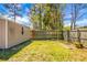 The backyard features a lush green lawn, bordered by a wooden fence, and a storage building at 201 Miami St, Ladson, SC 29456