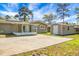 The backyard features a screened-in porch, a large patio, a storage shed, and a partially-fenced yard at 201 Miami St, Ladson, SC 29456