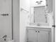 A clean, well-lit bathroom with a white vanity, sink, mirror, and combined tub and shower at 201 Miami St, Ladson, SC 29456