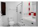 Bright bathroom features a toilet, shower-tub, and vanity with red accents at 201 Miami St, Ladson, SC 29456