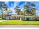 Beautiful single story home with a well manicured lawn, attached garage, and mature trees on a sunny day at 201 Miami St, Ladson, SC 29456