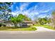 Well-kept home with an expansive front yard, healthy lawn, and lush landscaping under a brilliant blue sky at 201 Miami St, Ladson, SC 29456