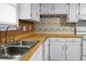 Kitchen showcasing a stainless steel sink and faucet, set into wood countertops at 201 Miami St, Ladson, SC 29456