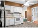 Kitchen featuring white cabinets, tiled backsplash, and decorative flooring at 201 Miami St, Ladson, SC 29456