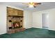 Living room featuring a brick fireplace, green carpet, and a ceiling fan at 201 Miami St, Ladson, SC 29456