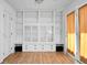 Well-lit living space featuring a built-in bookcase and glass-paneled cabinets with access to the outside at 201 Miami St, Ladson, SC 29456