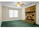 Cozy living room with a brick fireplace, green carpet, and natural light at 201 Miami St, Ladson, SC 29456