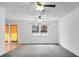 Bright living room featuring plush carpet, a large window, and two ceiling fans for optimal comfort at 201 Miami St, Ladson, SC 29456
