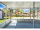 This screened porch has concrete flooring, metal screening, and a view of the backyard at 201 Miami St, Ladson, SC 29456