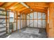 Interior view of the shed, showcasing wooden framing, shelving, and a concrete floor at 201 Miami St, Ladson, SC 29456