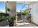 Relaxing balcony featuring a hanging hammock chair and lush greenery in a private outdoor space at 2011 N Highway 17 # 1100I, Mount Pleasant, SC 29466
