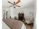 Cozy bedroom with an elegant ceiling fan, hardwood flooring, and a comfortable chair at 2011 N Highway 17 # 1100I, Mount Pleasant, SC 29466