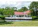 Clubhouse exterior on the water with patio seating surrounded by lush greenery and a red roof at 2011 N Highway 17 # 1100I, Mount Pleasant, SC 29466
